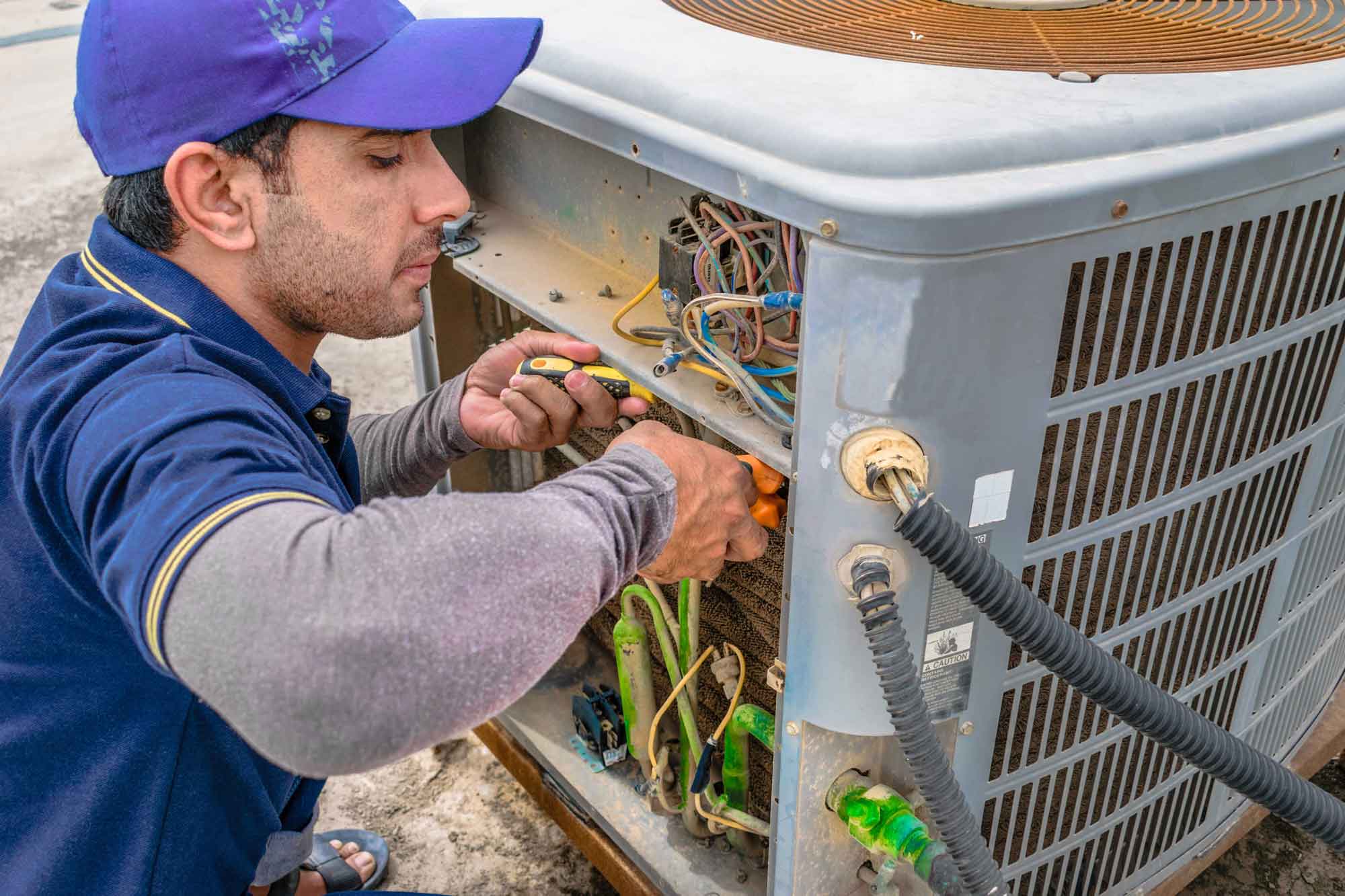 a technician fixing a HVAC