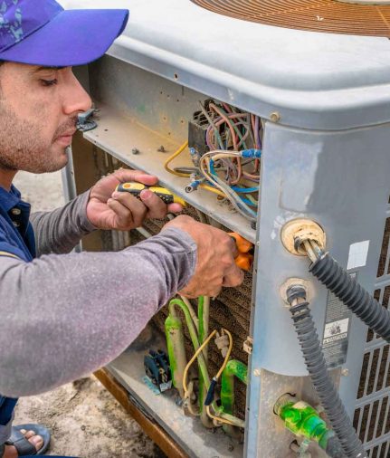 a technician fixing a HVAC